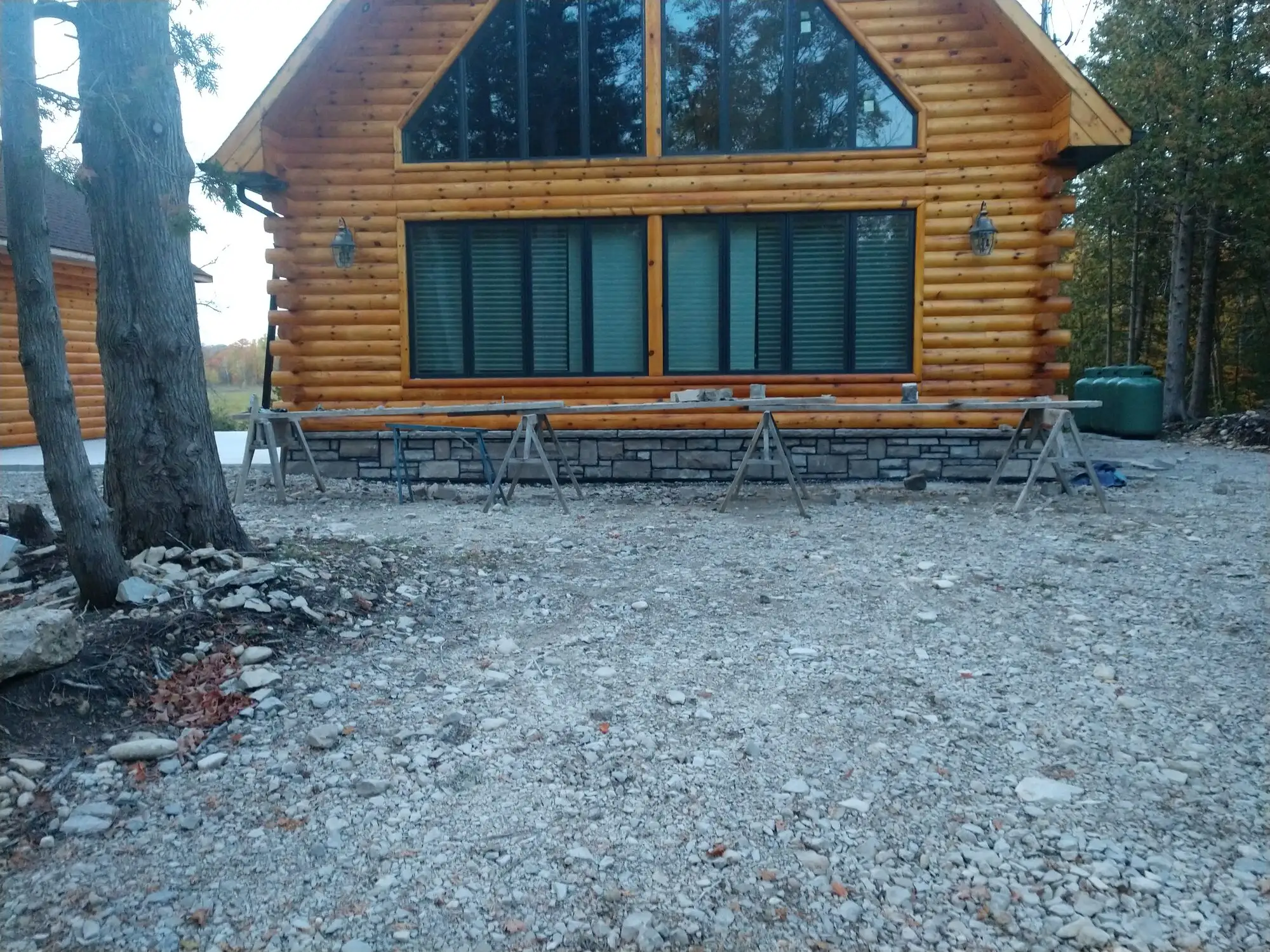 Cut-limestone masonry on a log home near the water